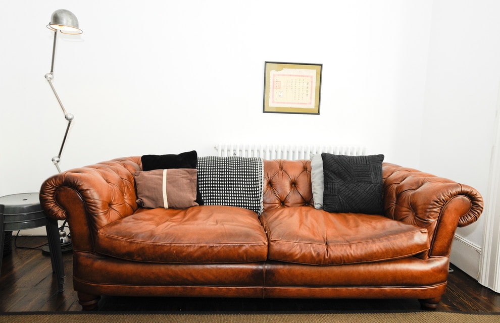Много мебели коричневый диван с полосатыми подушками