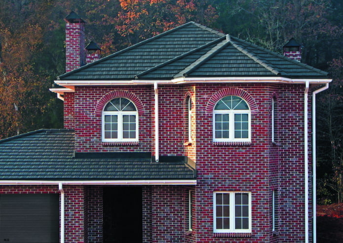 дом из темно-красного кирпича с черной крышей